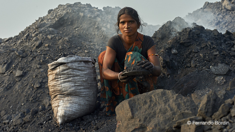 Dhanbad - Jaharia - Jharkhand - INDIA  - In Jharia in the State of Jharkhand in India, the depths of the earth have been burning for over a century. 
The fire devours the subsoil, the ground collapses, engulfing the houses of the poor villages overlooking an open-cast coal mine, one of the largest in the country. 
Every day, men, women and children illegally collect native coal to transform it for domestic use and resell it. 
Their source of survival. (2021)